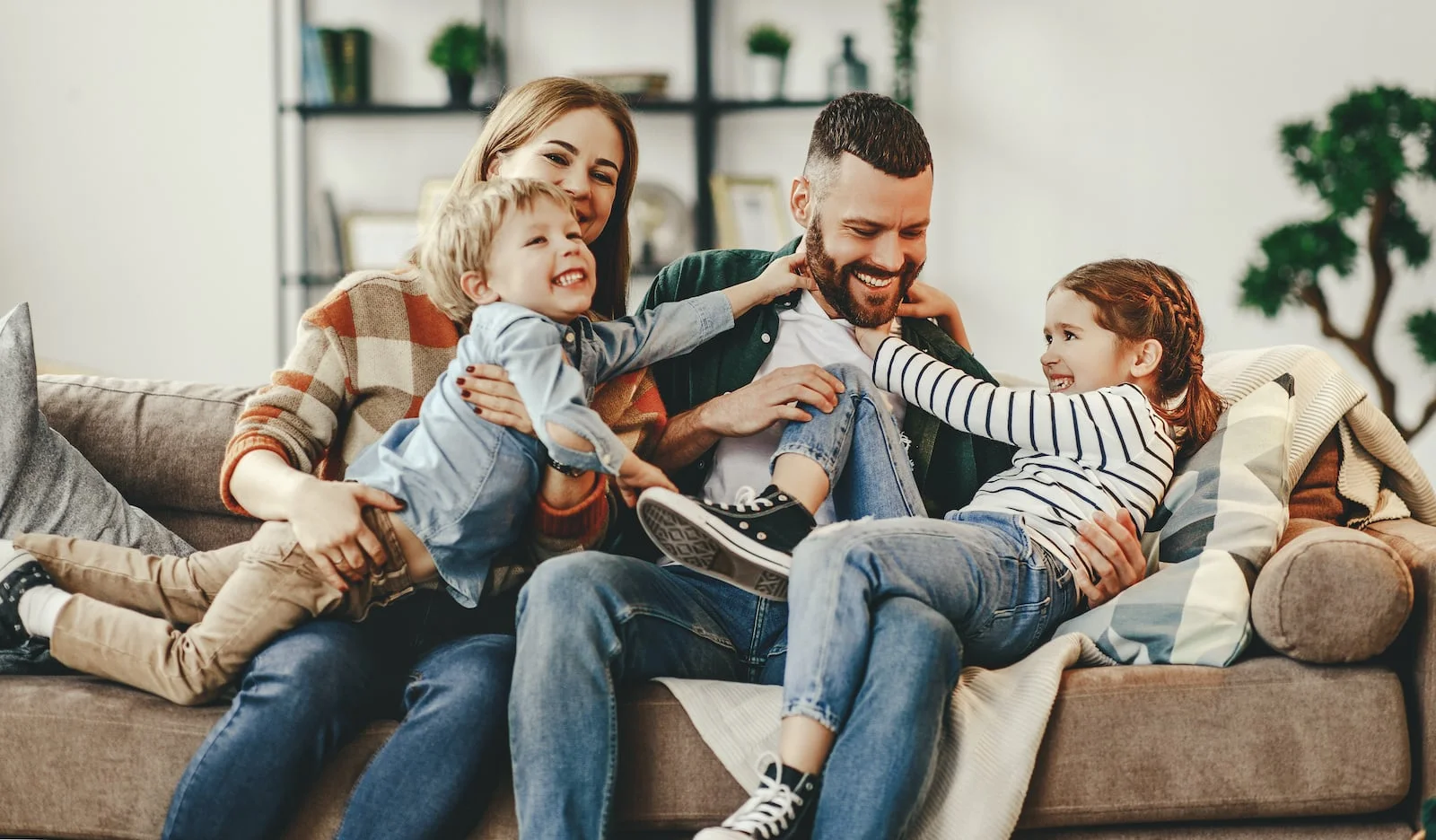 family smiling on couch